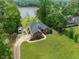 Picturesque aerial view of a waterfront home surrounded by mature trees and expansive lawn at 4612 River Farm Rd, Rocky Mount, NC 27803