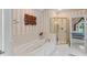 Bright bathroom features a soaking tub, glass enclosed shower, and modern finishes at 4612 River Farm Rd, Rocky Mount, NC 27803