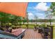 Wooden deck featuring outdoor furniture and a scenic view of the lake at 4612 River Farm Rd, Rocky Mount, NC 27803