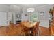 Bright dining room features a wood table set under a modern light fixture and wood flooring at 4612 River Farm Rd, Rocky Mount, NC 27803