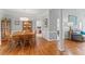 Open concept dining room features hardwood flooring, an area rug, and views into the living room at 4612 River Farm Rd, Rocky Mount, NC 27803