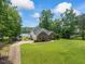 Charming home with lush lawn and a peaceful view of the lake at 4612 River Farm Rd, Rocky Mount, NC 27803
