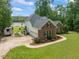 View of brick and siding home with RV parking and lake access at 4612 River Farm Rd, Rocky Mount, NC 27803