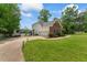 An attractive two-story home with a brick front, attached garage, and spacious yard with water access at 4612 River Farm Rd, Rocky Mount, NC 27803