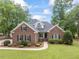 Charming brick home featuring mature landscaping, green lawn and neutral colors at 4612 River Farm Rd, Rocky Mount, NC 27803