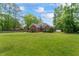 Beautiful single-Gathering home featuring a brick facade, lush front lawn, and well-maintained landscaping at 4612 River Farm Rd, Rocky Mount, NC 27803