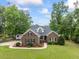 Charming brick home featuring mature landscaping, green lawn and neutral colors at 4612 River Farm Rd, Rocky Mount, NC 27803