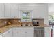Bright kitchen featuring granite counters, stainless appliances, and white cabinets at 4612 River Farm Rd, Rocky Mount, NC 27803