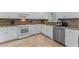 Clean kitchen features stainless steel appliances, tile floors, and white cabinets at 4612 River Farm Rd, Rocky Mount, NC 27803
