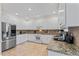 Well-lit kitchen features stainless steel appliances, tile floors, and ample cabinet space at 4612 River Farm Rd, Rocky Mount, NC 27803