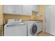 Functional laundry room with sink, cabinets, and modern washer and dryer at 4612 River Farm Rd, Rocky Mount, NC 27803