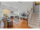 Living room with hardwood flooring features a fireplace, comfortable sofas, and a staircase at 4612 River Farm Rd, Rocky Mount, NC 27803