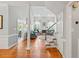 Open-concept living area with gleaming hardwood floors, a cozy fireplace, and abundant natural light at 4612 River Farm Rd, Rocky Mount, NC 27803