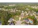 Gorgeous aerial view of a home in a wooded neighborhood with a pool and a circular driveway at 48 Falling Oak Ct, Clayton, NC 27520