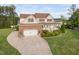 Charming two-story home boasts a manicured lawn, a brick-accented garage, and a welcoming front porch at 48 Falling Oak Ct, Clayton, NC 27520