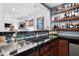 Stylish bar area with dark countertops, custom cabinetry, and an open view to the kitchen at 48 Falling Oak Ct, Clayton, NC 27520