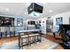Basement entertainment area with a wet bar, multiple screens, and a Carolina blue theme at 48 Falling Oak Ct, Clayton, NC 27520