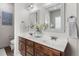 Bright bathroom featuring a dual sink vanity with wood cabinets and white countertops at 48 Falling Oak Ct, Clayton, NC 27520