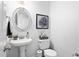 Classic bathroom features a pedestal sink, stylish mirror, and a toilet at 48 Falling Oak Ct, Clayton, NC 27520