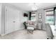 Cozy bedroom featuring large windows, a comfortable chair, and a chandelier at 48 Falling Oak Ct, Clayton, NC 27520