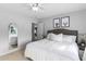 Inviting bedroom features a comfortable bed with plush pillows, neutral decor, and a decorative arched mirror at 48 Falling Oak Ct, Clayton, NC 27520