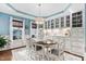 Elegant dining room with chandelier, custom cabinetry, and light blue accent walls at 48 Falling Oak Ct, Clayton, NC 27520