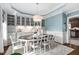 Elegant dining room with custom cabinetry, a modern chandelier, and light blue accent walls at 48 Falling Oak Ct, Clayton, NC 27520