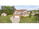 Charming two-story home boasts a manicured lawn, a brick-accented garage, and a welcoming front porch at 48 Falling Oak Ct, Clayton, NC 27520