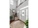 Bright foyer featuring a staircase with iron spindles and a decorative front door with sidelights at 48 Falling Oak Ct, Clayton, NC 27520