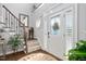 Welcoming foyer with hardwood floors, staircase, and an elegant front door with glass details at 48 Falling Oak Ct, Clayton, NC 27520