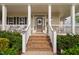 Charming covered front porch and brick steps to the front door with a 'No Soliciting' sign at 48 Falling Oak Ct, Clayton, NC 27520