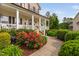 Inviting front porch with lush landscaping and a stone pathway leading to the entrance at 48 Falling Oak Ct, Clayton, NC 27520