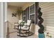 View of the front porch showing rocking chairs, decor, and views from the front windows at 48 Falling Oak Ct, Clayton, NC 27520