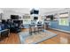 Spacious game room with Carolina Tarheels theme, multiple TVs, and basketball court rug at 48 Falling Oak Ct, Clayton, NC 27520