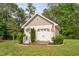 Garage exterior with a charming design, enhanced by beautiful landscaping at 48 Falling Oak Ct, Clayton, NC 27520