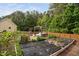 Garden with a pergola swing surrounded by growing plants at 48 Falling Oak Ct, Clayton, NC 27520
