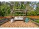 Cozy garden with a pergola swing and plants at 48 Falling Oak Ct, Clayton, NC 27520