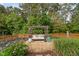 Garden with a pergola swing, flowers and plants at 48 Falling Oak Ct, Clayton, NC 27520
