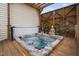 Relaxing hot tub area featuring a Buddha statue and decorative lattice for privacy and ambiance at 48 Falling Oak Ct, Clayton, NC 27520