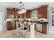 Charming kitchen featuring custom cabinets, granite countertops, an island with seating, and stainless-steel appliances at 48 Falling Oak Ct, Clayton, NC 27520