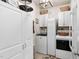 Bright laundry room with white cabinets, modern washer and dryer, and stylish decor accents at 48 Falling Oak Ct, Clayton, NC 27520