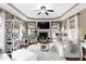 Spacious living room with a fireplace, tray ceiling, and large windows offering natural light at 48 Falling Oak Ct, Clayton, NC 27520