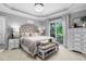 Serene main bedroom featuring a king-sized bed, soft lighting, and access to a private outdoor space at 48 Falling Oak Ct, Clayton, NC 27520