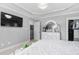 Spacious main bedroom featuring tray ceilings, a TV, a closet, and an ensuite bath entrance at 48 Falling Oak Ct, Clayton, NC 27520