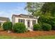 Charming outbuilding with stylish details surrounded by manicured landscaping at 48 Falling Oak Ct, Clayton, NC 27520