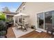 Covered outdoor dining area with a dining set and a large umbrella for shade at 48 Falling Oak Ct, Clayton, NC 27520