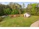 Aerial view of the yard featuring a storage shed and a garden with wooden fence at 48 Falling Oak Ct, Clayton, NC 27520