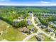 Aerial view of a suburban neighborhood featuring tree-lined streets and meticulously maintained lawns and landscaping at 5004 Clowser Minnow Ct, Wake Forest, NC 27587