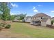 Large back yard with full wooden fence and lush green grass at 5004 Clowser Minnow Ct, Wake Forest, NC 27587