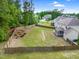Expansive fenced backyard featuring lush green grass and mature trees, perfect for outdoor activities and relaxation at 5004 Clowser Minnow Ct, Wake Forest, NC 27587